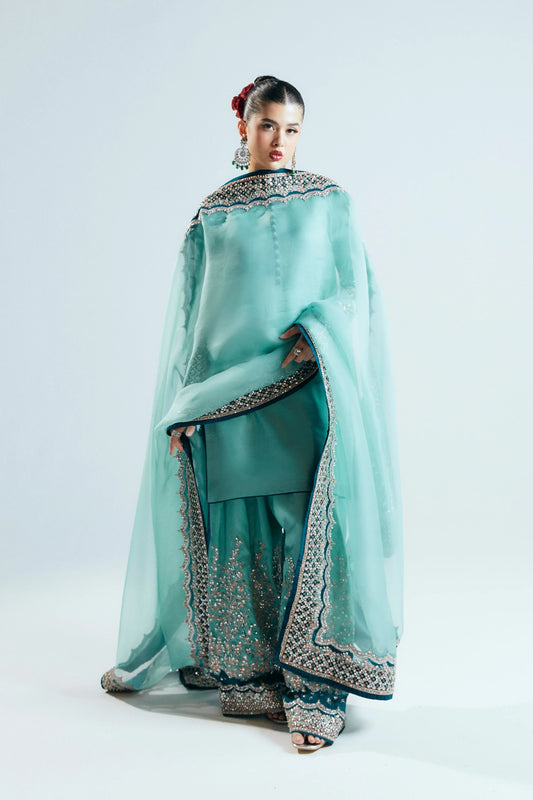 Woman wearing a traditional outfit with a light blue dupatta on a white background