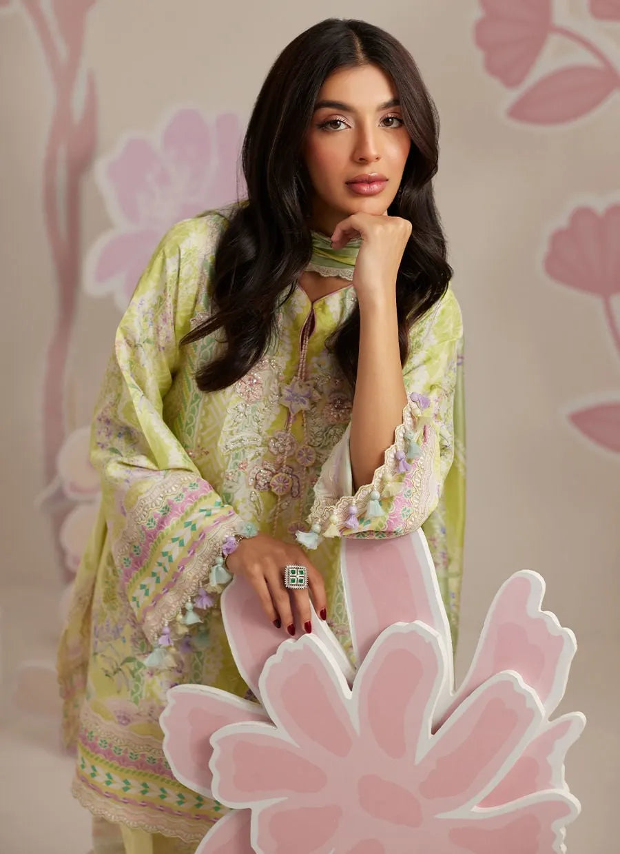 Woman in a floral dress posing with a decorative flower against a floral-patterned background