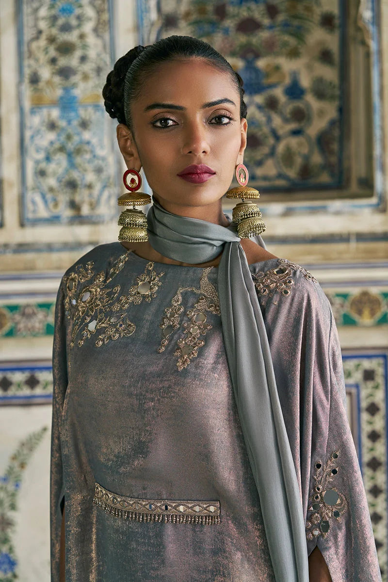 Woman wearing an ornate traditional outfit with a decorative background
