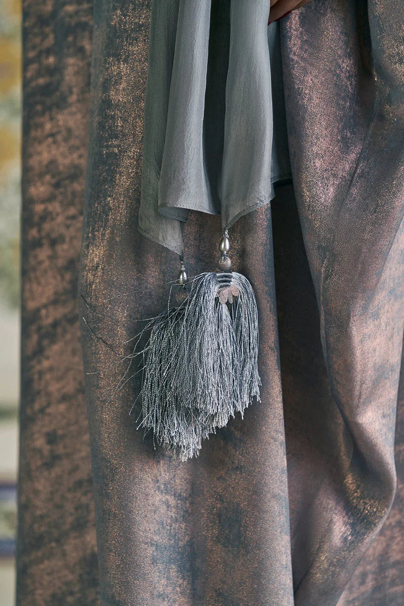 Close-up of a textured fabric with tassels hanging from it
