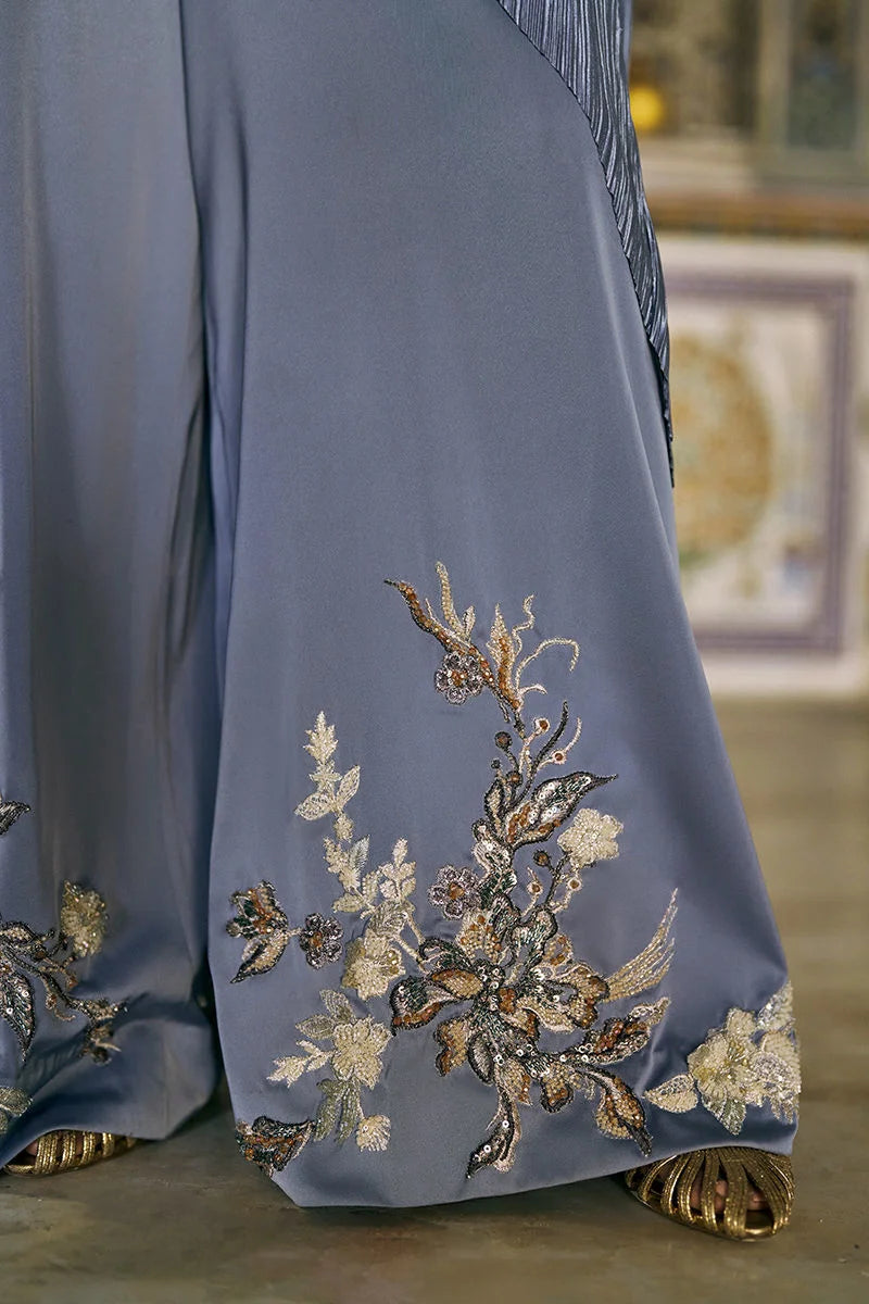 Blue dress with intricate floral embroidery on a blurred background
