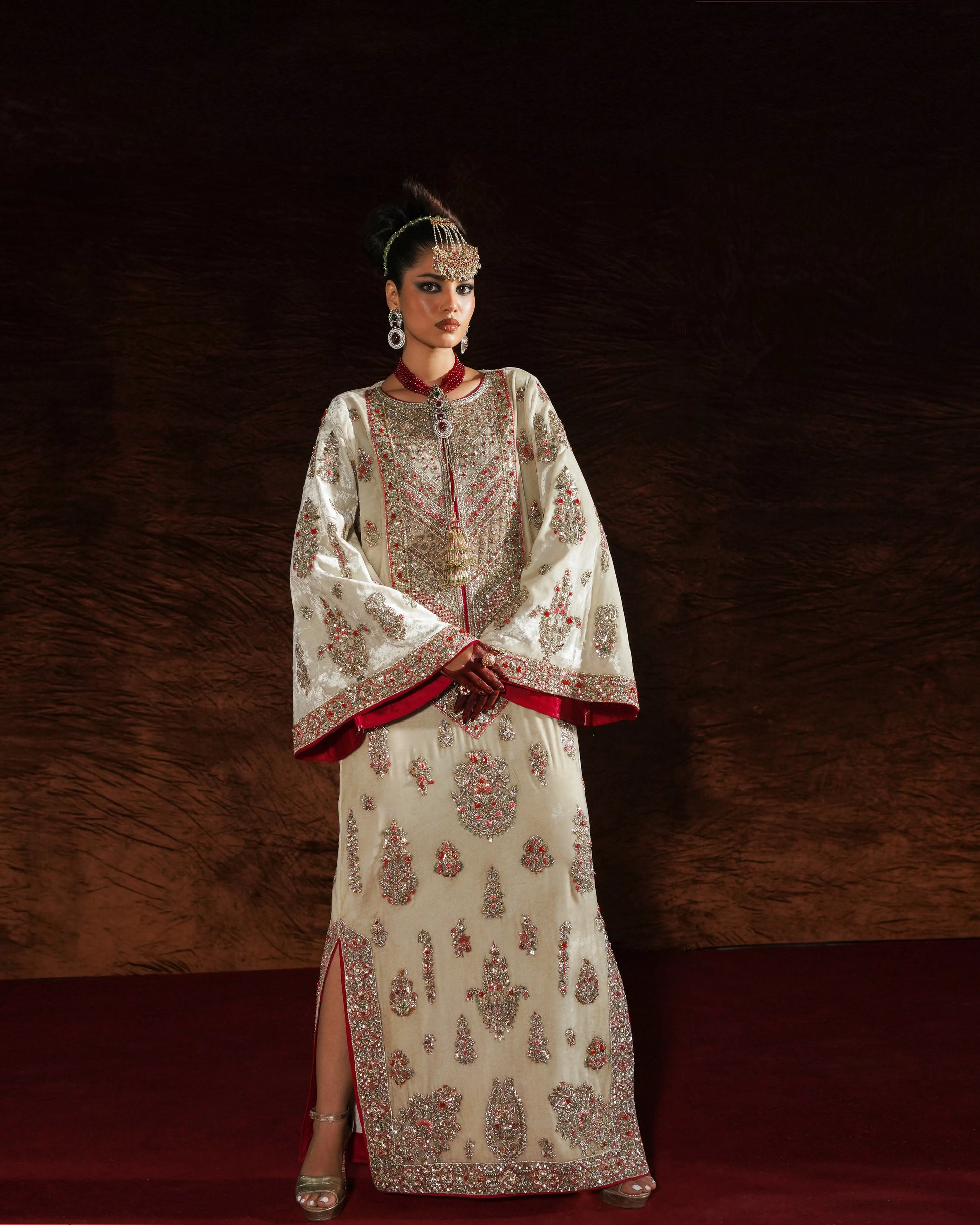 Woman wearing an ornate traditional outfit with a dark background