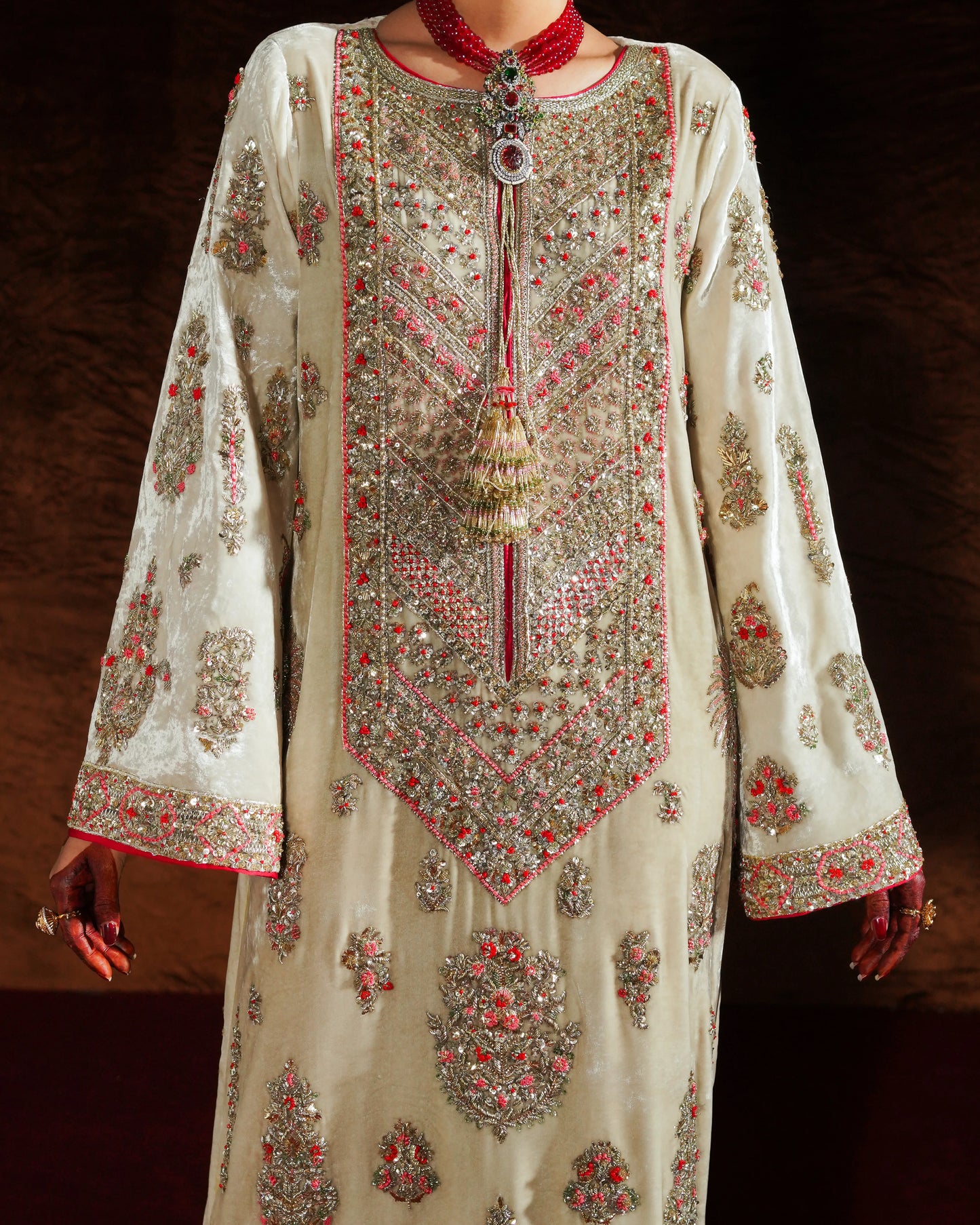 Elegant embroidered dress with intricate patterns on a dark background