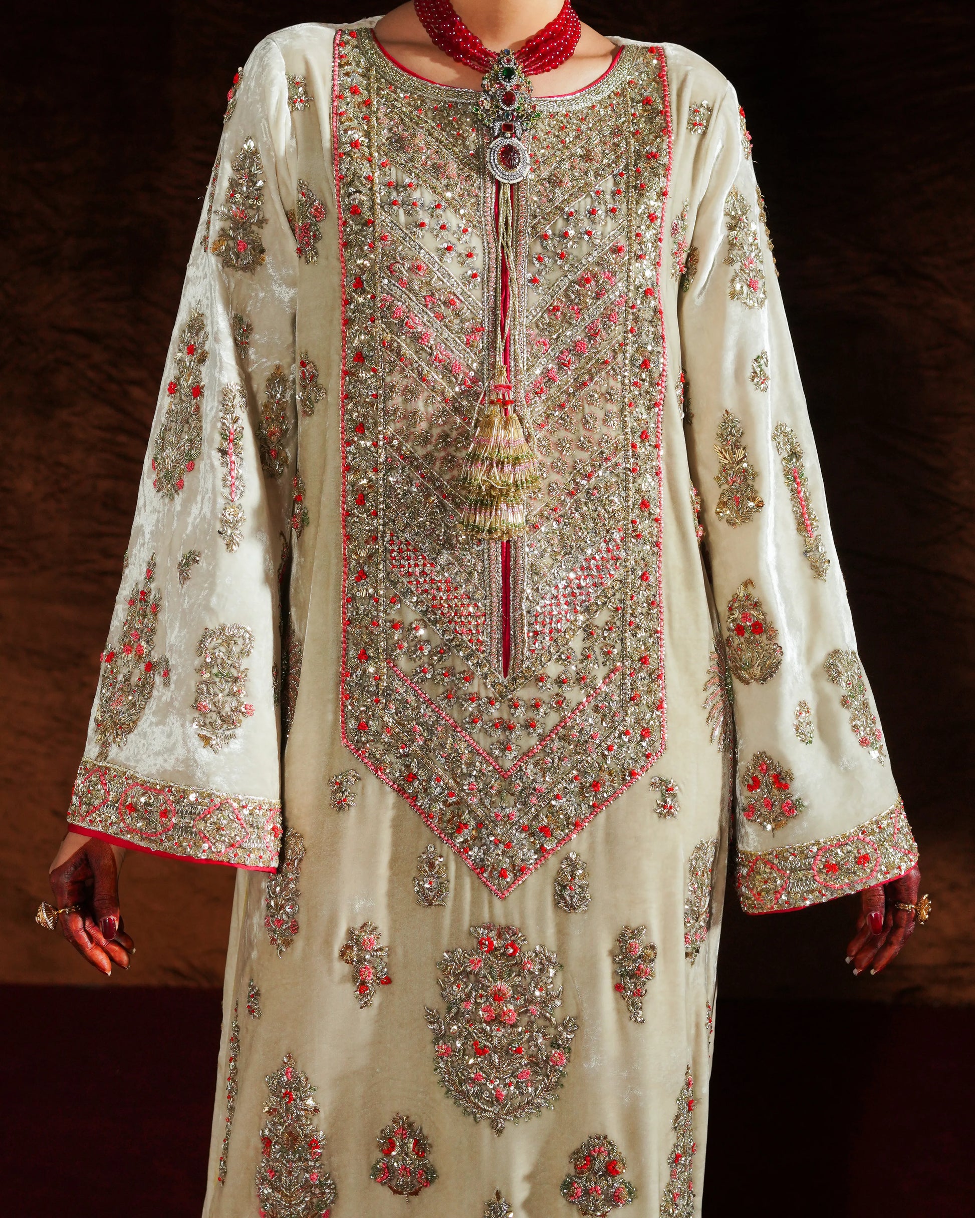 Elegant embroidered dress with intricate patterns on a dark background