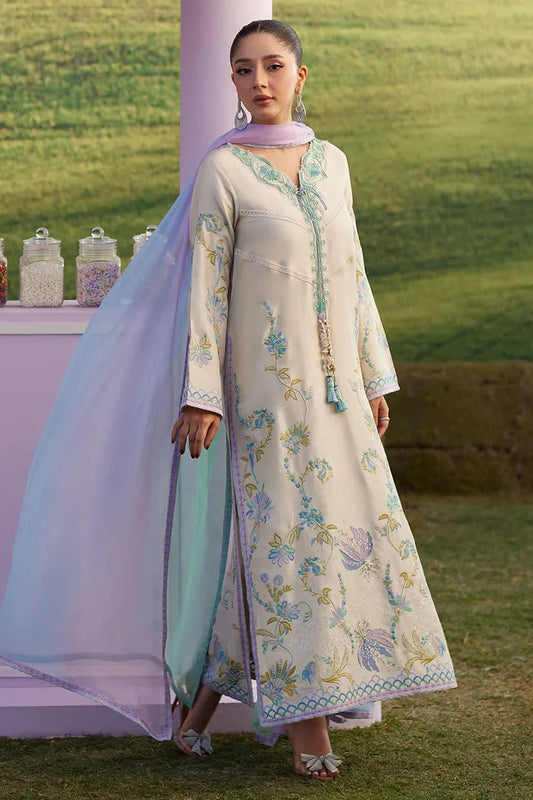 Woman in a traditional outfit with a floral design standing outdoors.