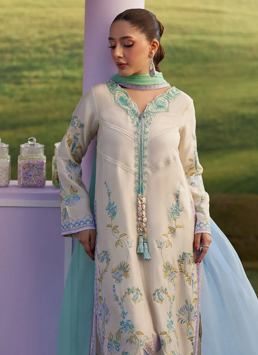 Woman in a floral dress standing outdoors with a scenic background