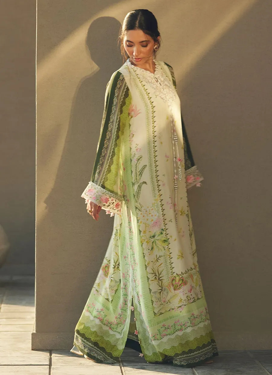 Woman wearing a floral dress with a green dupatta against a neutral background