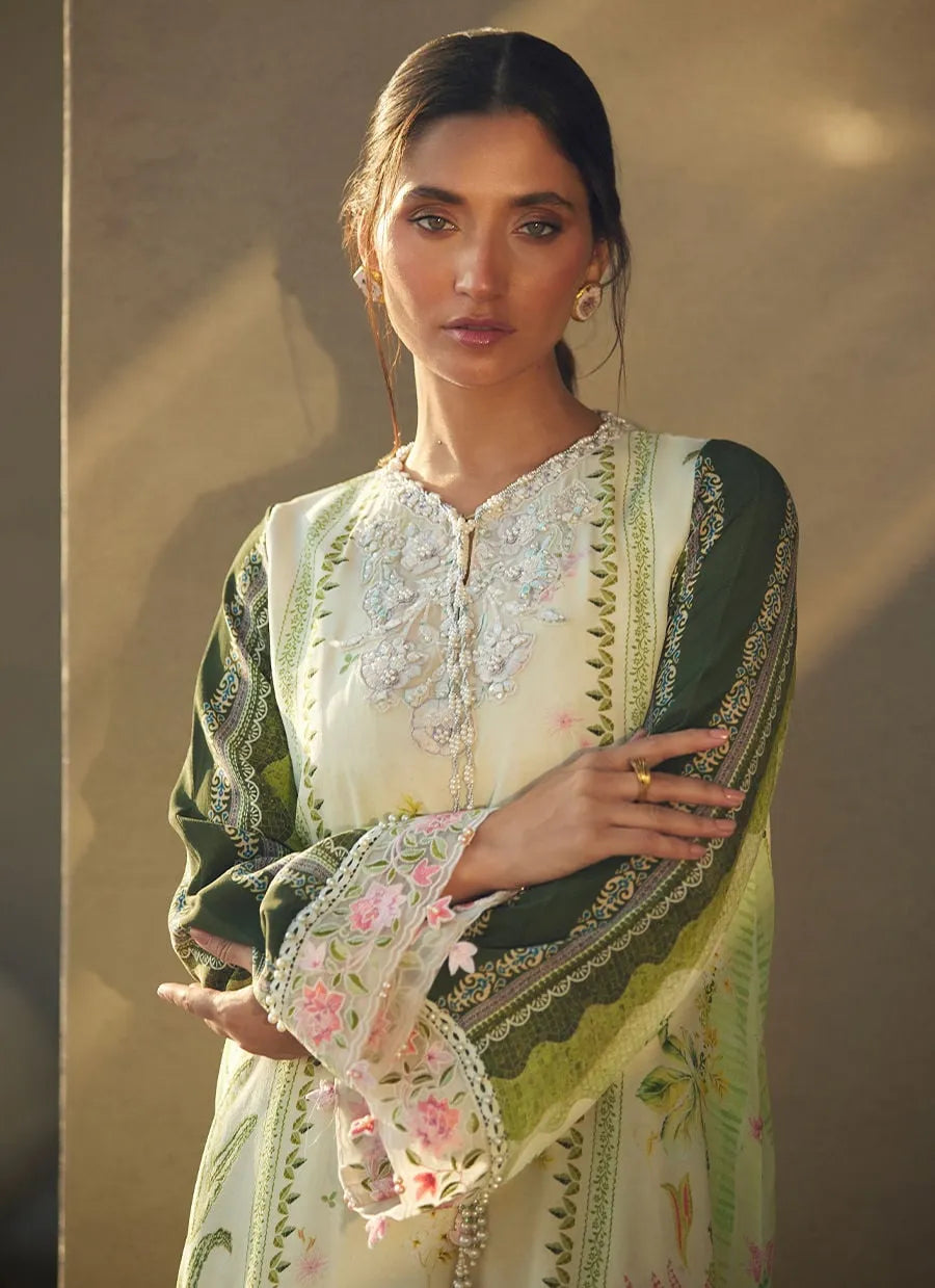 Woman wearing a traditional embroidered outfit with a neutral background