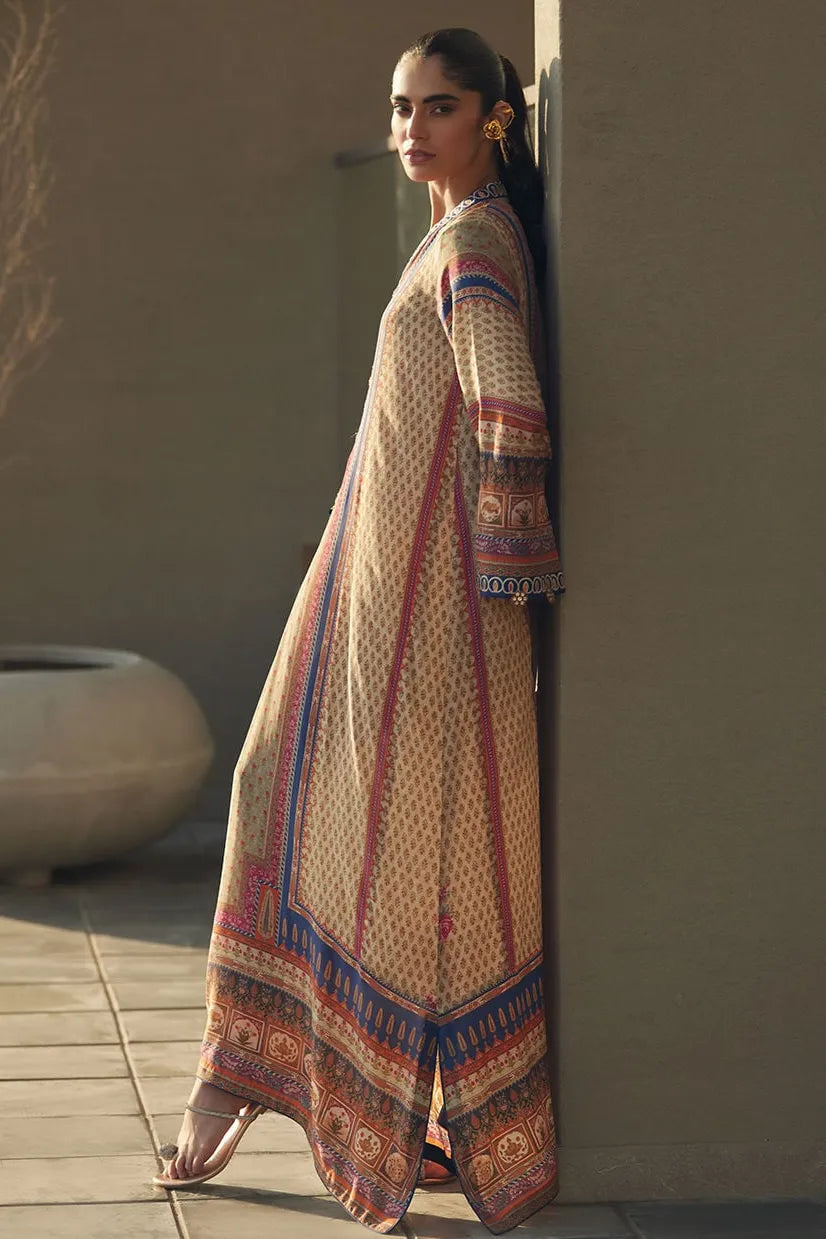 Woman wearing a patterned dress leaning against a wall outdoors.