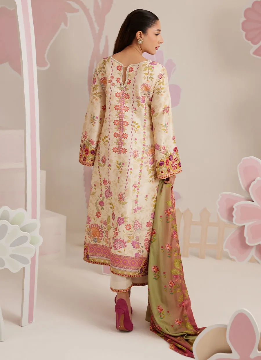 Woman wearing a floral embroidered outfit with a pink and white background