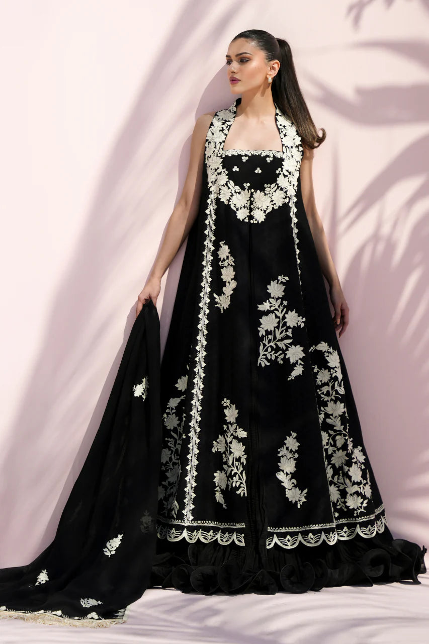 Black dress with white floral embroidery on a plain background