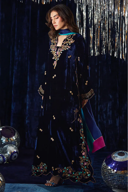 Woman in a dark blue embroidered outfit with a festive background