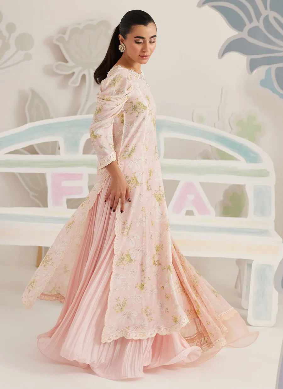 Woman wearing a pink floral dress with a blurred background