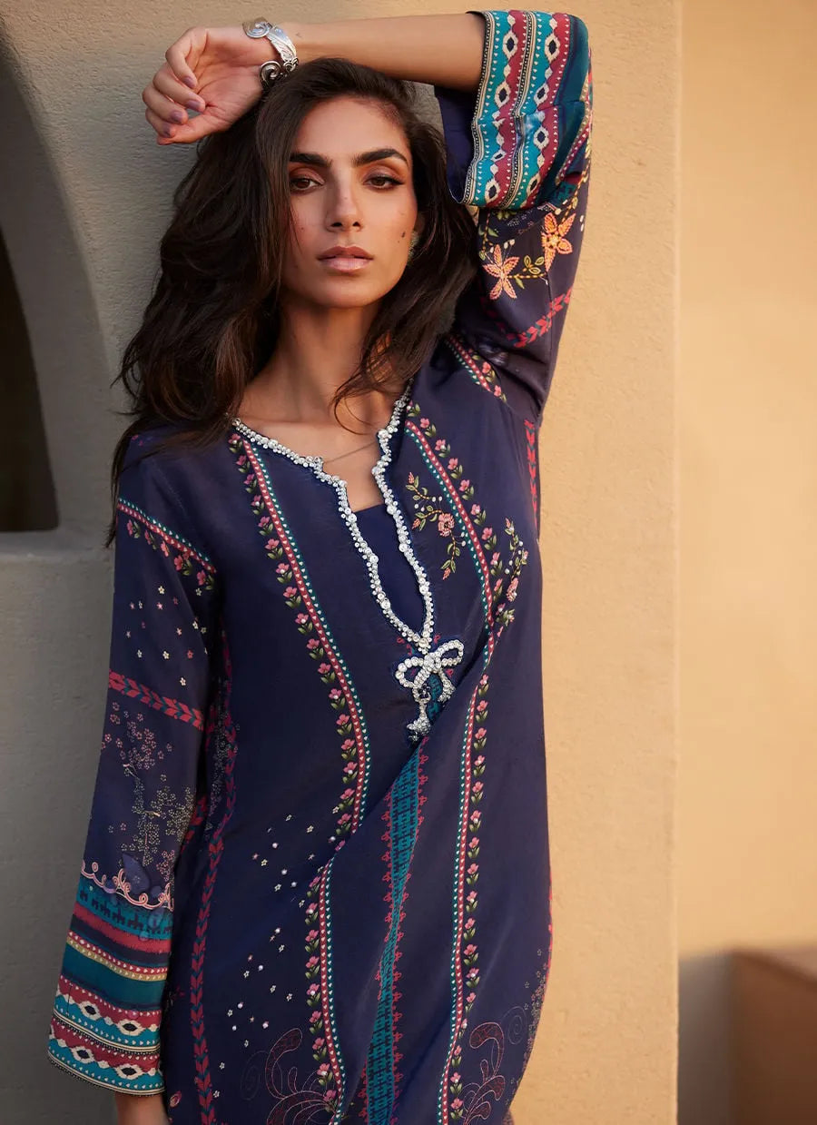 Woman wearing a patterned dress with a neutral background